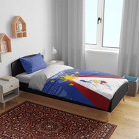 Blue bedding set on bed with flag triangle map and golden sun motif, matching pillows