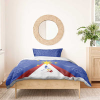 Blue bedding set on bed with flag triangle map and golden sun motif, two pillows