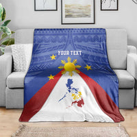 Folded blue Philippines map blanket with eight-rayed sun, yellow stars, red and white design
