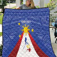 Blue personalized quilt spread flat with Philippines map, eight-rayed sun, and star symbols