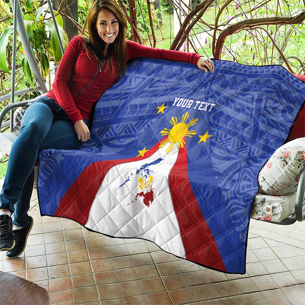 Blue personalized quilt laid out with Philippines map, eight-rayed sun, and star decorations