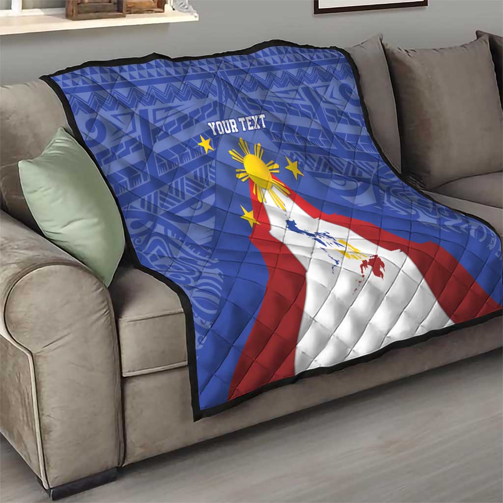 Blue personalized quilt on couch with Philippines map, eight-rayed sun, and star symbols