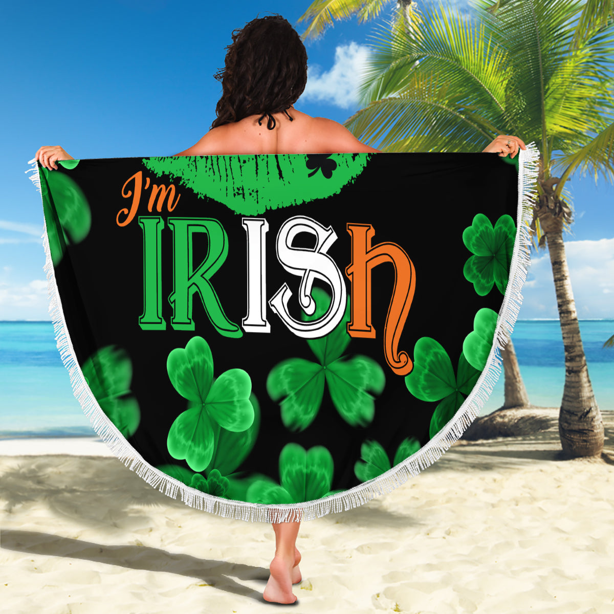 Black round beach blanket with 'I'm Irish' lips print and green clovers, white braided fringe edge