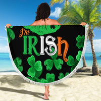 Black round beach blanket with 'I'm Irish' lips print and green clovers, white braided fringe edge