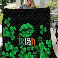 Black quilt with green clovers and Irish-themed text design, diamond stitched top.