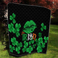 Black quilt with green clovers, Irish-themed heart-like graphic, diamond-quilted texture.