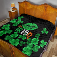 Black quilt on bed with green clovers and Irish-themed text across the surface.