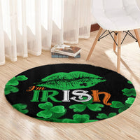 Black round area rug showing green kiss-lips, “I’m Irish” lettering, and clover shapes