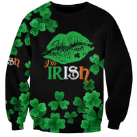 Unisex black crewneck sweatshirt with green shamrocks and Kiss Me lips Irish graphic