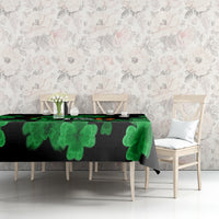 Black St. Patrick's Day tablecloth with green clover pattern along tabletop