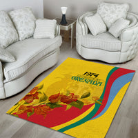 Gold area rug showing 1974 Grenada text, red-and-blue curve stripes, and floral accents