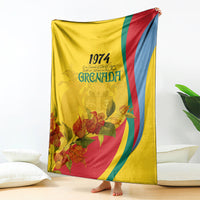 Yellow Grenada flag-style blanket with 1974 text, floral print, and curved color stripes