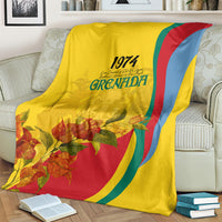 Yellow Grenada flag-style blanket with 1974 text, floral bouquet print, and curved rainbow stripes