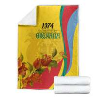 Yellow Grenada flag-style blanket with 1974 lettering, floral pattern, and red-green-blue curved stripes