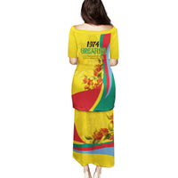 Gold long dress with short sleeves, 1974 GRENADA text, floral print and flag colors
