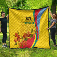 Yellow flag-style quilt showing Grenada 1974 emblem, red and blue diagonal stripe, floral bouquet
