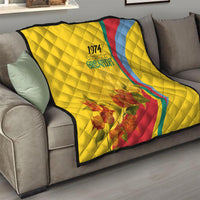 Yellow throw quilt with quilted pattern, Grenada 1974 text, red and blue curve, floral bouquet