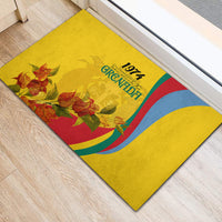 Yellow rubber doormat with Grenada 1974 logo, multicolor curved stripes, and floral art