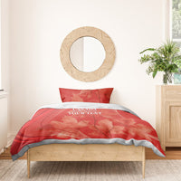 Red duvet cover set on bed with pillow shams, maple leaf pattern and Canada text