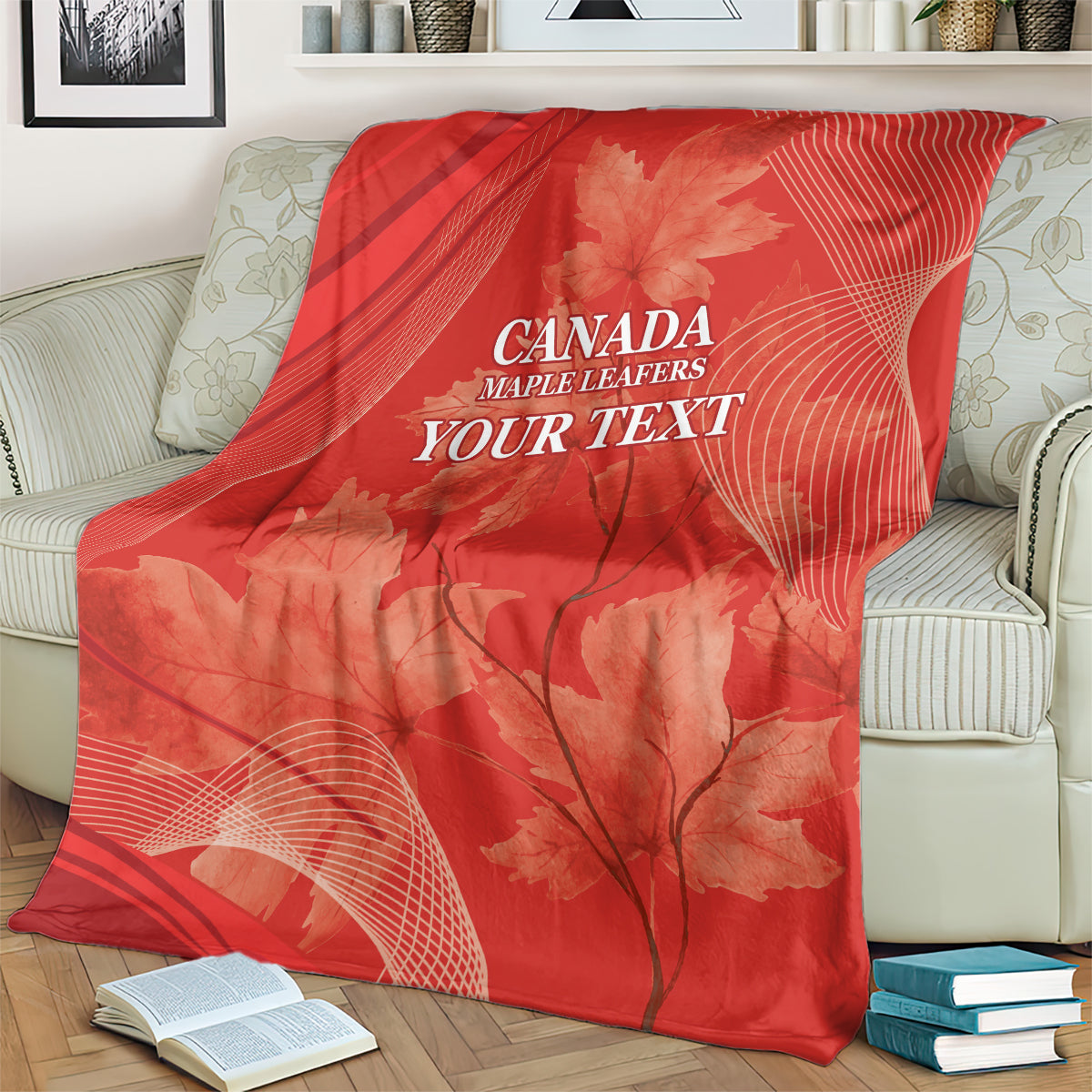 Red Canada Maple Leafs blanket on cream sofa, maple leaf motif and 'YOUR TEXT'