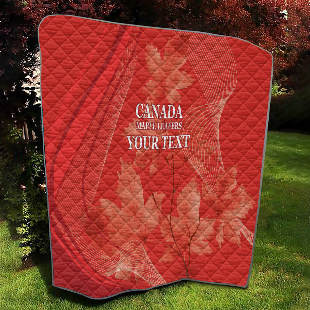 Red quilt with diamond quilting and white 'CANADA MAPLE LEAFERS YOUR TEXT' print