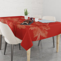 Red rectangular tablecloth with maple leaf and swirling line print
