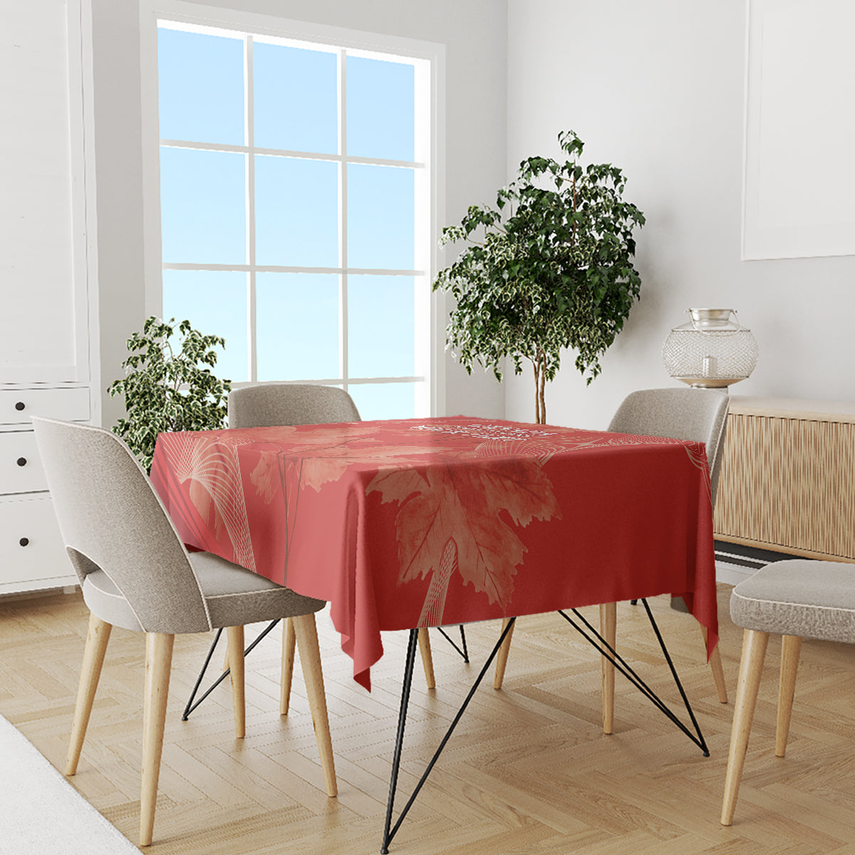 Red tablecloth with large maple leaf and line pattern on dining table