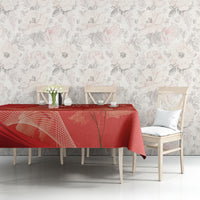 Red tablecloth with maple leaf print on rectangular dining table