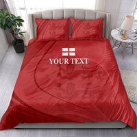 Red bedding set with duvet and two pillowcases, emblem panel at the center