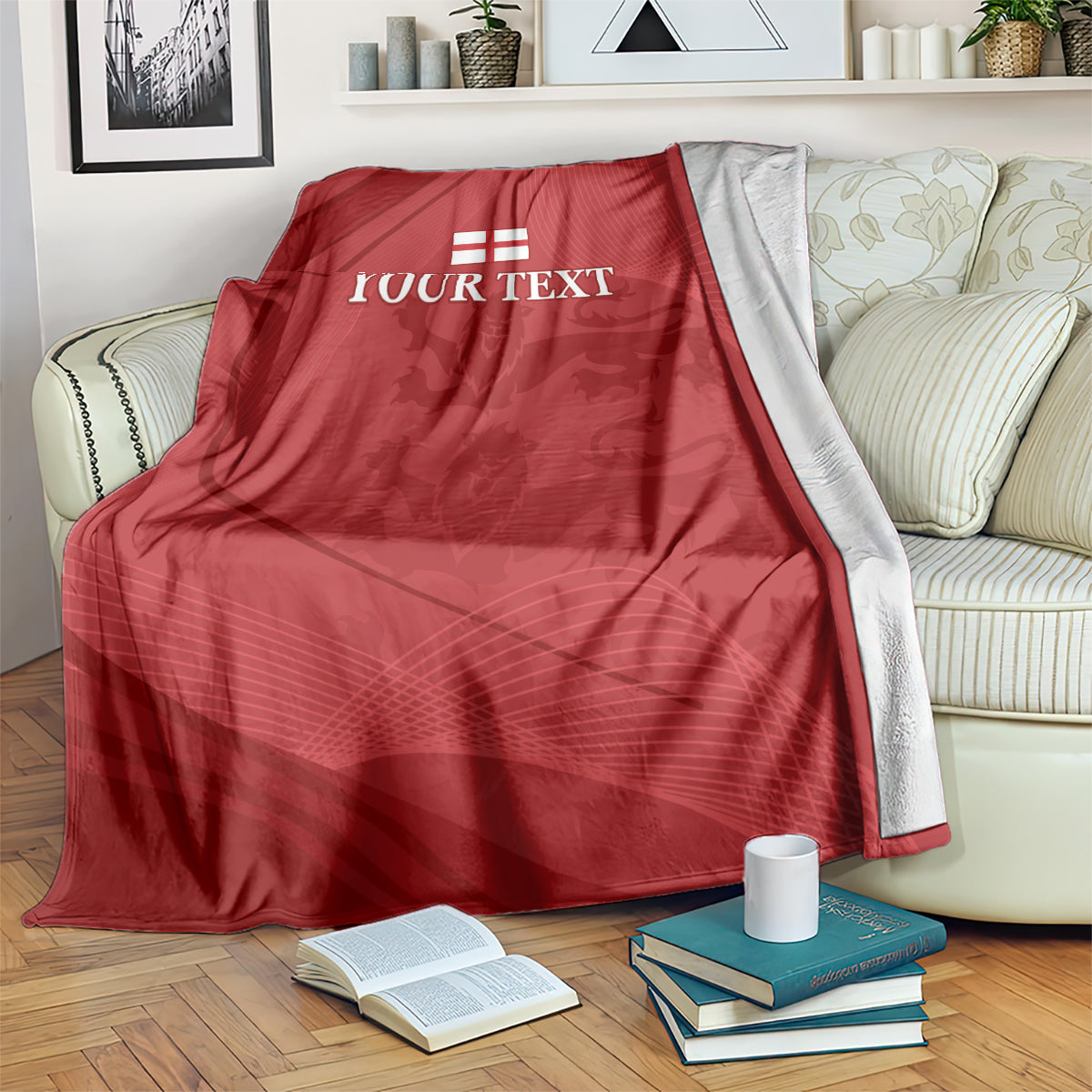 Red cricket blanket with white England emblem and 'YOUR TEXT' on a couch