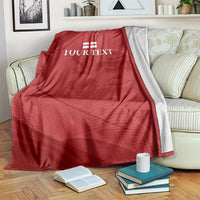 Red cricket blanket with white England emblem and 'YOUR TEXT' on a couch