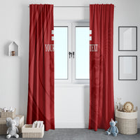 Red window curtain pair with custom text and abstract crest pattern, hanging straight