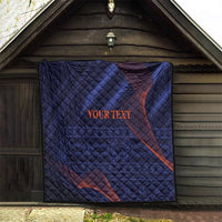 Dark blue quilt with diamond stitching and red swirls, “YOUR TEXT” printed in middle