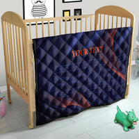Blue quilt with red ribbon-like swirl lines, “YOUR TEXT” centered on crib blanket