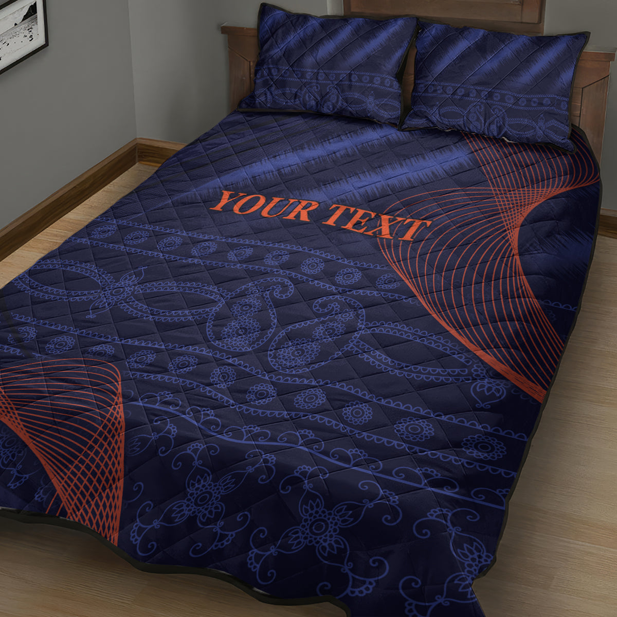 Blue quilt bed set with two pillowcases, orange 'Your Text' and red curved accents