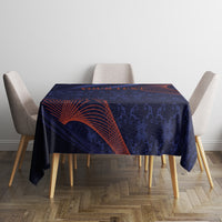 Blue tablecloth on rectangular table with orange-red curved lines and dark motif borders