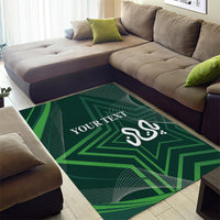 Green area rug with geometric star pattern, Arabic-style script, and “YOUR TEXT”