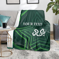 Green patterned blanket on a sofa seat with “YOUR TEXT” and calligraphy emblem