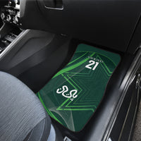 Green car floor mat with '21' and Arabic emblem, rear seat close-up