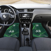 Green car floor mats with '21' and Arabic emblem, center console view