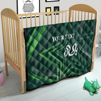 Green quilt with diamond quilting, white “YOUR TEXT” and Arabic-style emblem on bed
