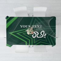 Green tablecloth with geometric background, floral emblem, and text "YOUR TEXT"
