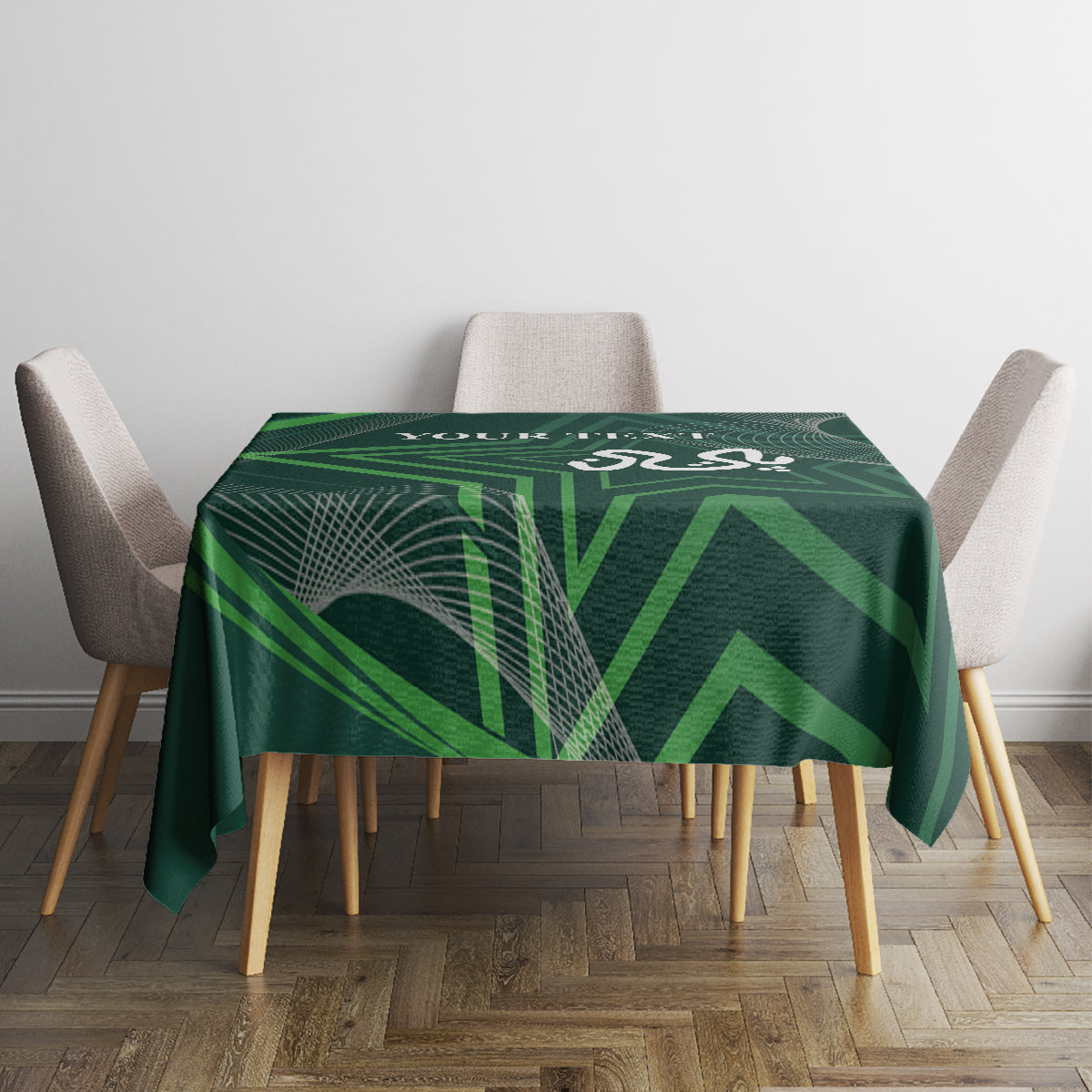 Green geometric tablecloth covering dining table with four chairs around it