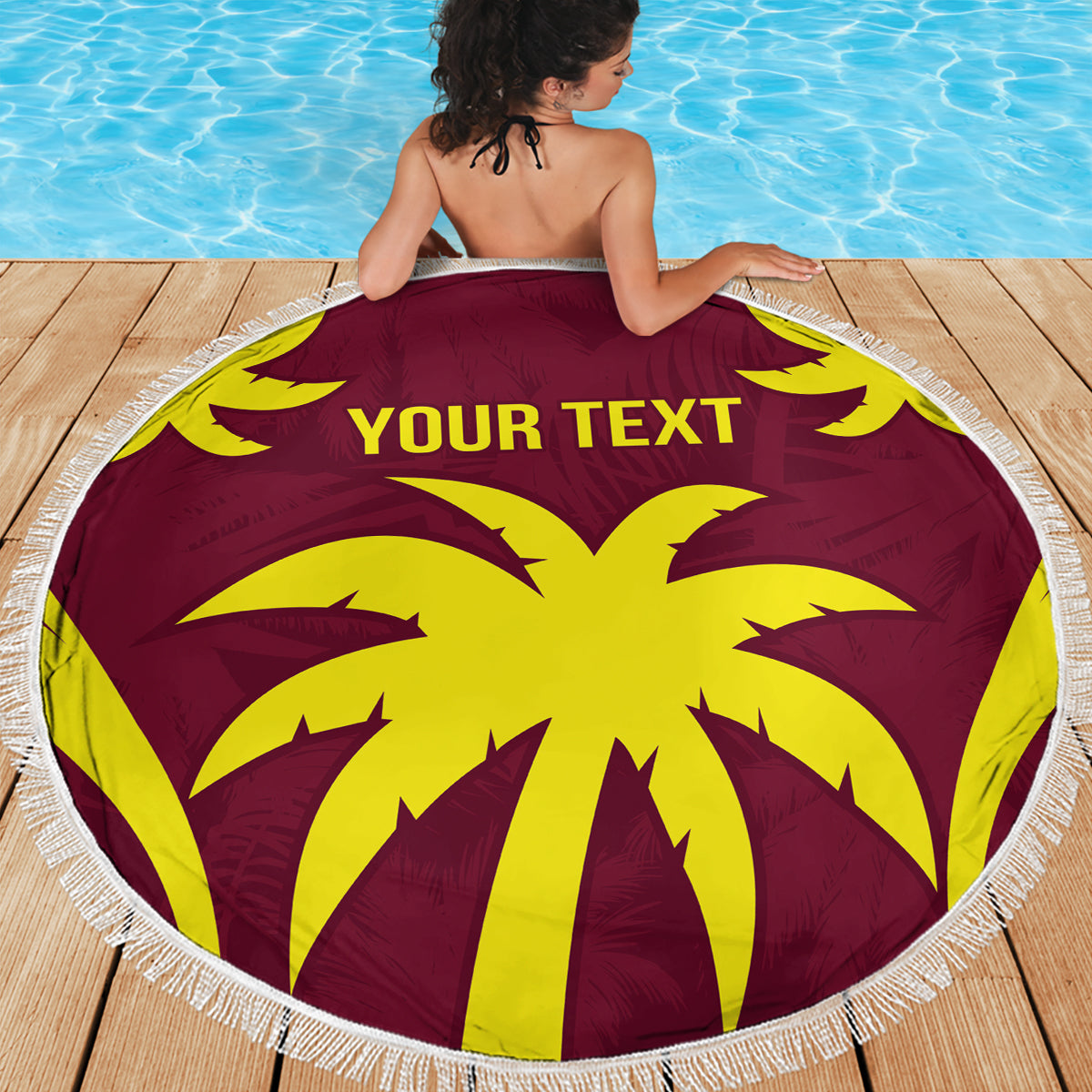 Maroon round beach blanket with yellow palm center and 'YOUR TEXT', white fringe.