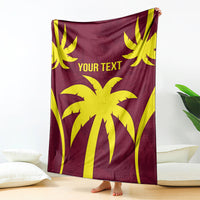 Maroon blanket with large yellow palm-and-sunburst design and "YOUR TEXT" lettering
