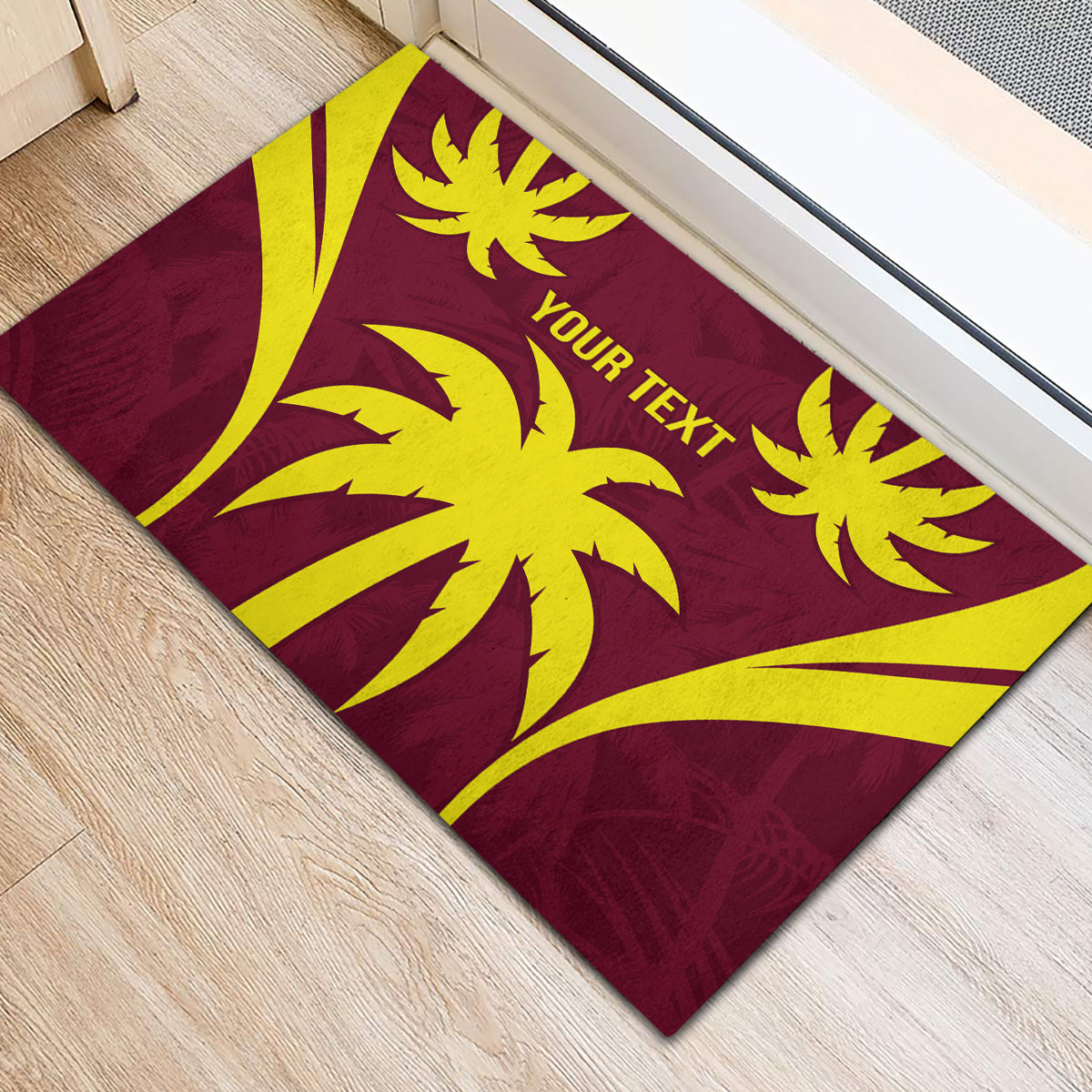 Maroon rubber doormat with yellow sunburst graphics and 'YOUR TEXT' center