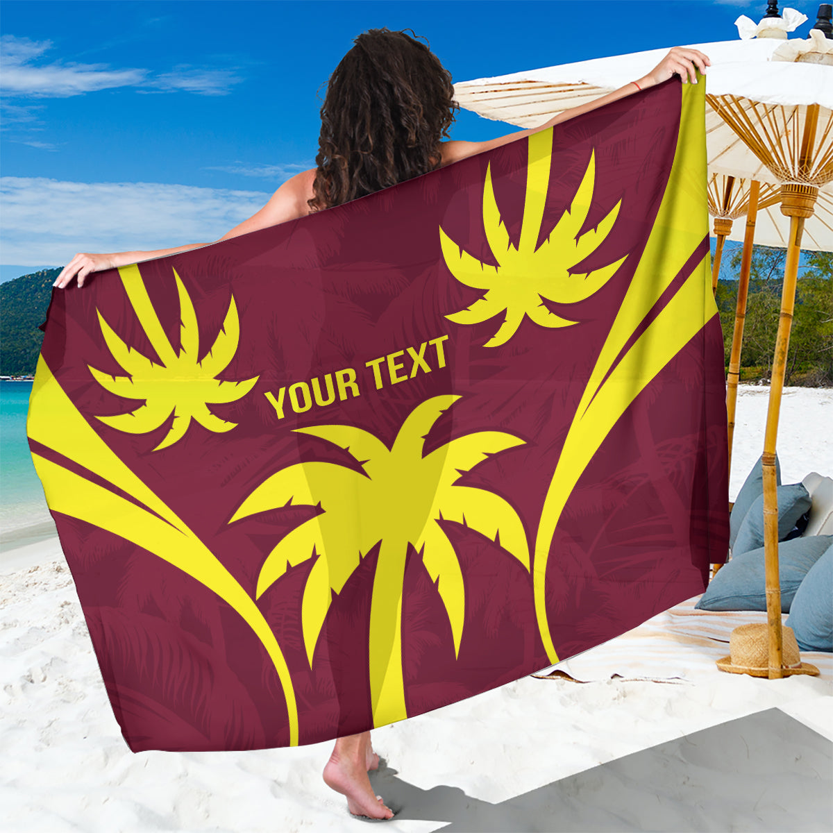 Maroon sarong blanket with yellow flower-like emblems and 'YOUR TEXT' lettering