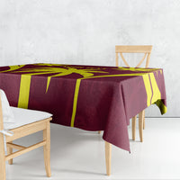 Maroon and yellow cricket-themed tablecloth draped on bench table, corner detail