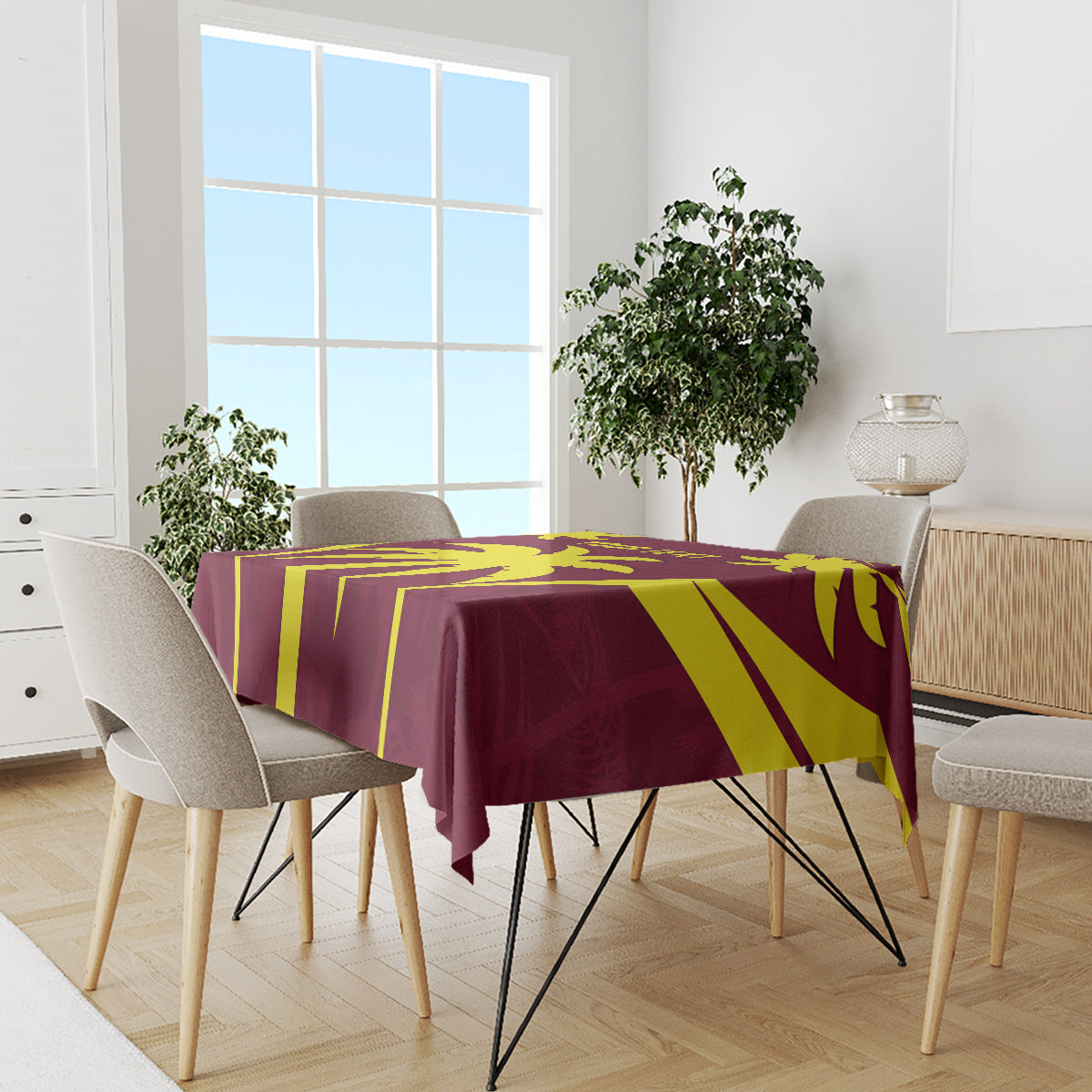 Maroon and yellow tablecloth with geometric cricket-style pattern on dining setup