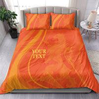 Orange duvet cover with matching pillowcases, swirling pattern and 'YOUR TEXT' centered.